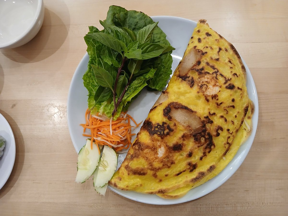 Banh xeo, the crisp turmeric rice-flour crepe, being served in Vietnam