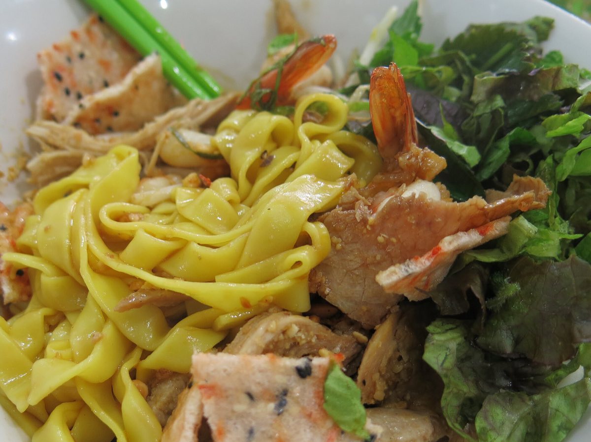A bowl of mi Quang on a Da Nang table, the dish that anchors the city prices