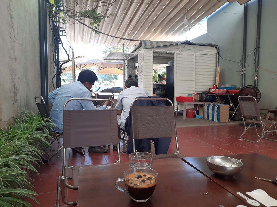 The interior of a Vietnamese coffee shop with people working